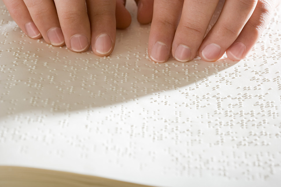 One woman reading braille